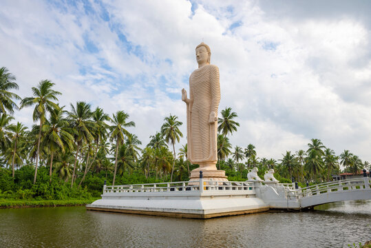 PERALIYA, SRI LANKA - FEBRUARY 14, 2020: Sculpture of a standing Buddha.  Memorial to the victims of the tsunami. Tsunami Honganji Viharaya