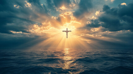 Rays of light illuminate a cross above tranquil waters during a dramatic sunset