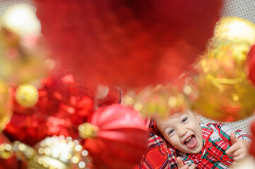 Joyful Children in Festive Plaid Pajamas Surrounded by Christmas Ornaments