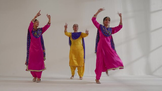 Three Sikh Women performing bhangra during Baisakhi celebration