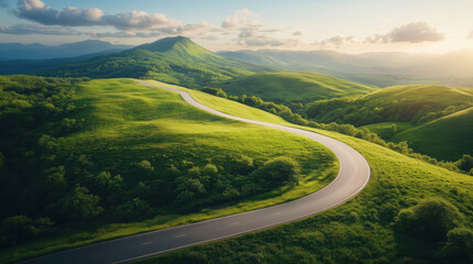 Scenic winding road through lush green hills at sunset