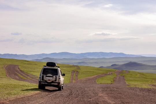 Japanese SUV on a dirt mongolian road in mountains