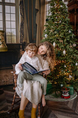 Cozy indoor reading time by the Christmas tree with child during holiday season