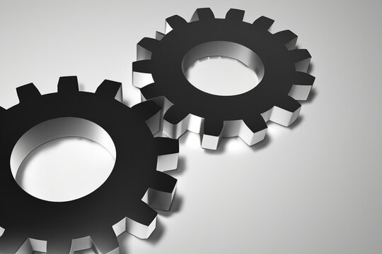 Group of gears on a white background. A gray background with iron gears. Small gray tool lying on a gray background. Small iron gears and tools lying on lifestyle a gray background.