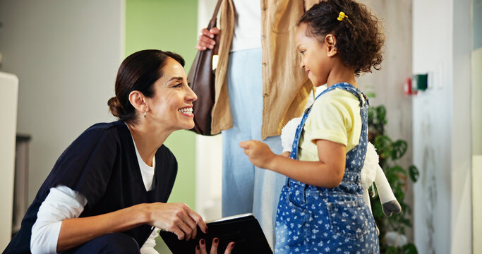 Dentist, tablet and child in waiting room of clinic for consultation, appointment and medical service. Healthcare, happy and woman with girl for teeth cleaning, oral care and dental hygiene in lobby