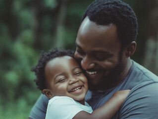 Fototapeta premium A heartwarming moment of a father holding his child close, both smiling lovingly. Captures familial bond, warmth, and happiness in an outdoor setting with soft focus.