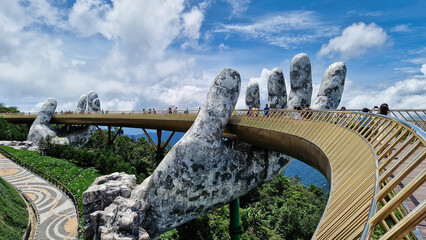 Bridge with hand statue in scenic mountain landscape Vietnam Da Nang Ba Na Hills Asia