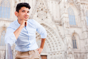 Obraz premium yYoung European guy in blue shirt walking around city