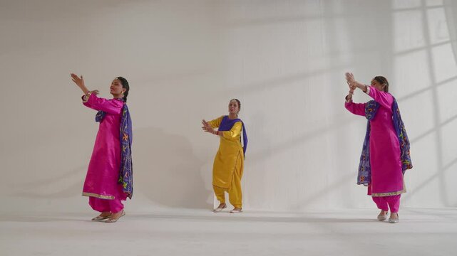 Three Sikh Women performing bhangra during Baisakhi celebration