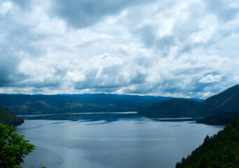 Fototapeta premium cloudy sky over the sea and mountains, natural landscape background.