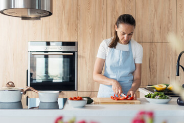 Housewife preparing fresh vegetables in a modern kitchen for a healthy meal