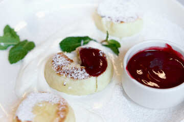 Cottage cheese pancakes, syrniki with fresh berries and jam for breakfast 