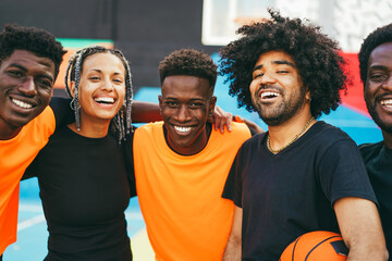 African friends playing basketball outdoor - Urban lifestyle concept - Focus on center latin guy with curly hair