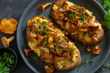 toasts with scrambled eggs and fried chanterelle mushrooms
