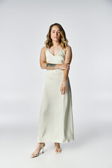 A young woman with vitiligo stands confidently in a simple studio, showcasing her beauty.