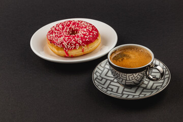 Wonderful fragrant espresso and a fresh donut with red glaze