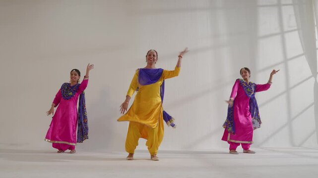 Three Sikh Women performing bhangra during Baisakhi celebration