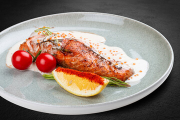 Salmon steak with cream sauce and red caviar