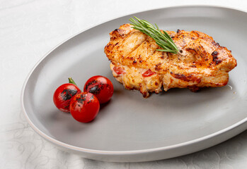 Grilled chicken breast with rosemary and cherry tomatoes