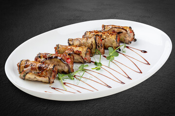 A savory meat roll stuffed with roasted eggplant, creating a flavorful blend of textures and tastes.