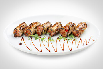 A savory meat roll stuffed with roasted eggplant, creating a flavorful blend of textures and tastes.