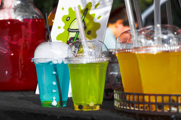 sweet cold fresh cocktails in plastic cups summer time festival counter colorful bright view