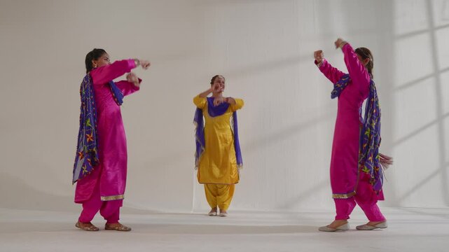 Three Sikh Women performing bhangra during Baisakhi celebration