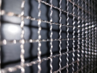 Close up view of stainless steel net with beautiful bokeh