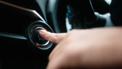 A young woman starting a modern car with a push button. Concept of convenience, innovative technology, and modern vehicles.