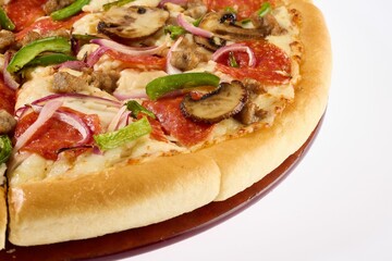 Vibrant pizza topped with mashrooms, bell, peppers, onions, pepperoni, and sausage.