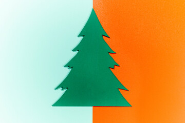 Closeup view of a wooden Christmas tree ornament on a colored background