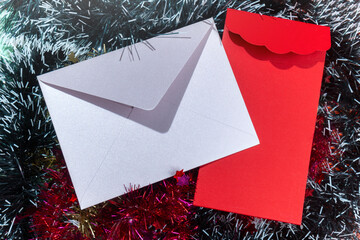 Closeup view of two envelopes with a Christmas ornament background