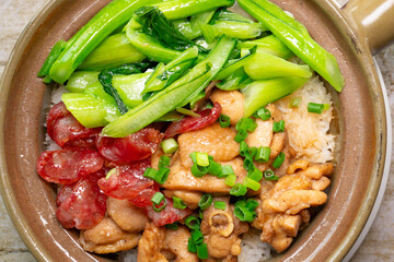 top view clay pot rice of chicken and Chinese style sausage and vegetable at horizontal composition