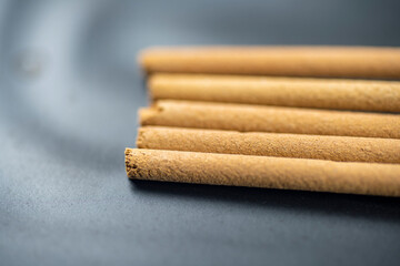 Closeup view of incense sticks for ritual, praying, or aromatic scented on a black background