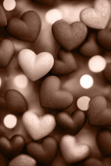 Fototapeta premium Mocha mousse, brown heart shapes in various shades with bokeh background, soft focus