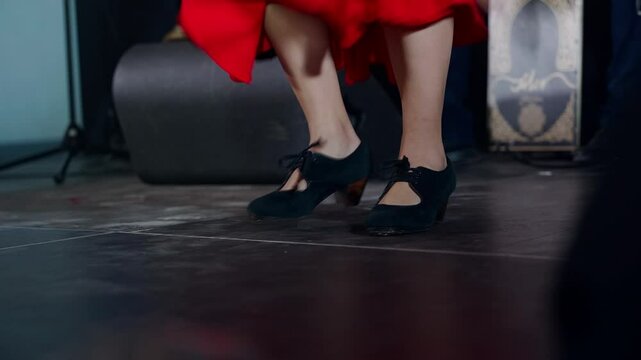 Woman wearing shows zapateado performing on stage closeup
