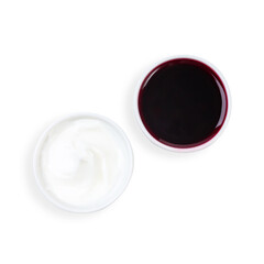 Sour cream and jam, on a plate, top view, on a white background, isolated.