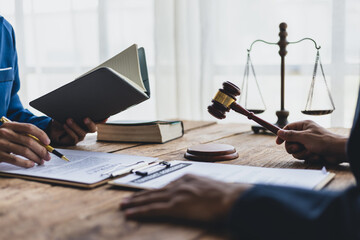 Lawyer is providing legal advice to a client. Legal advisor is discussing and explaining the terms...