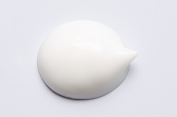 A sample of a white moisturizing cosmetic cream for the body or face