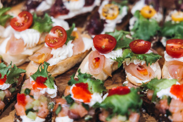 Catering table, beautifully decorated banquet with variety different food snacks appetizers on christmas corporate birthday party event or wedding celebration, canape, salad, delicatessen setting