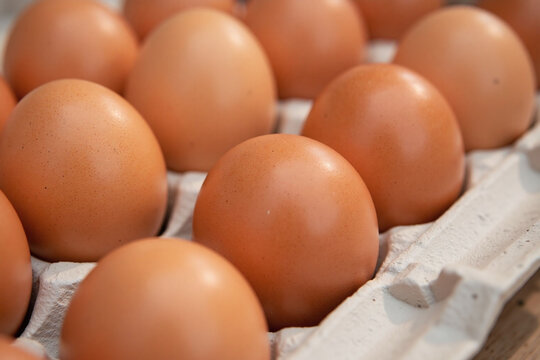 Carton of brown eggs waxy carton hexagonal pattern fresh
