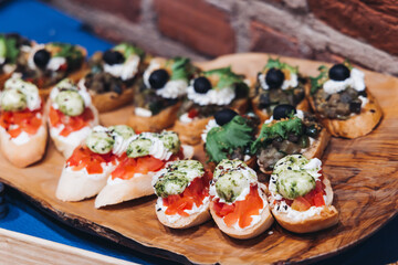 Catering table, beautifully decorated banquet with variety different food snacks appetizers on christmas corporate birthday party event or wedding celebration, canape, salad, delicatessen setting