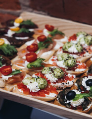 Catering table, beautifully decorated banquet with variety different food snacks appetizers on christmas corporate birthday party event or wedding celebration, canape, salad, delicatessen setting