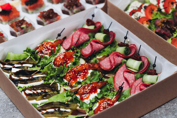 Catering table, beautifully decorated banquet with variety different food snacks appetizers on christmas corporate birthday party event or wedding celebration, canape, salad, delicatessen setting