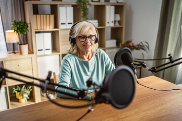 senior woman radio host enjoy while record podcast with man colleague