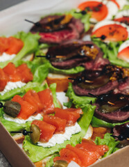 Catering table, beautifully decorated banquet with variety different food snacks appetizers on christmas corporate birthday party event or wedding celebration, canape, salad, delicatessen setting