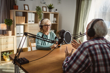 senior woman radio host enjoy while record podcast with man colleague
