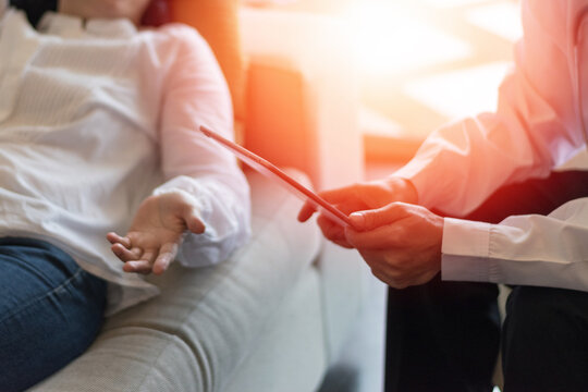 Psychologist conducting a psychotherapy session with a patient. The professional doctor and empathetic interaction highlights mental health care, active listening, and guidance, set in a calm,  - Powered by Adobe