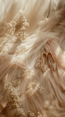 A pastel flatlay with peach fabric, satin slippers and dried flowers.