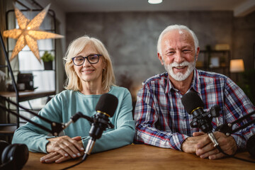 Portrait of senior man host and senior woman guest in the podcast